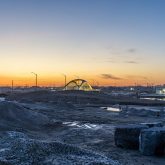 A bridge sitting on a construction site at sunrise.