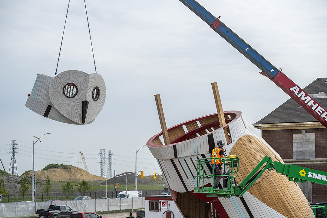 the owl’s head being lifted by a crane.