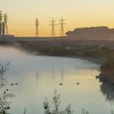 A river with the sunrise in the background.