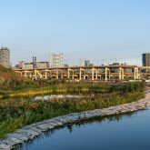 A river with a city in the background.