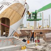A headless snowy owl structure in a construction site.